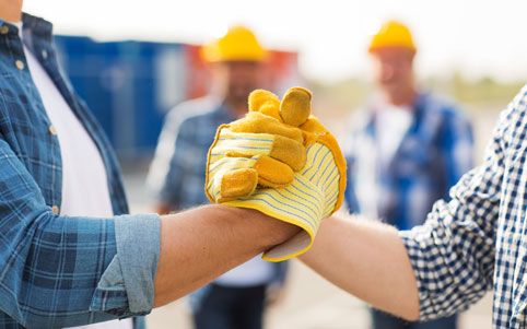two construction workers handshake